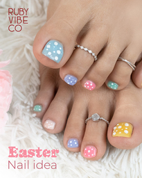 An Easter nail idea by Ruby Vibe Co featuring pastel-colored toenails with white polka dots
