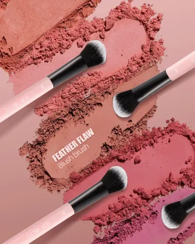 Promotional cosmetic photoshoot for Ruby Vibe Co. blush brushes arranged on crushed powder texture